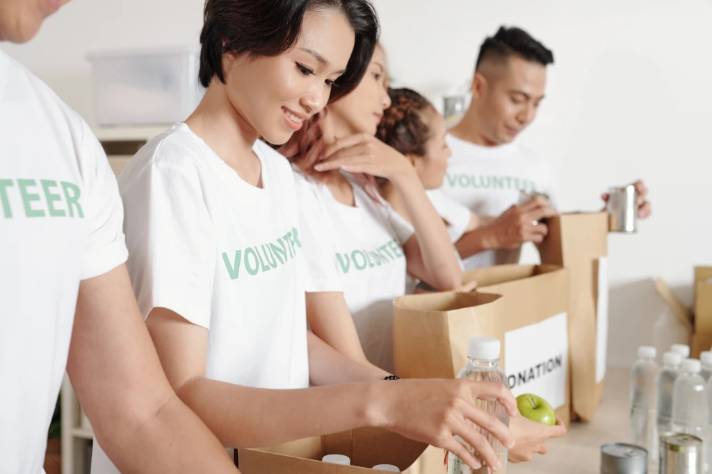 group young volunteers packing groceries paper packages when working shipping delivery charitable organization (1)